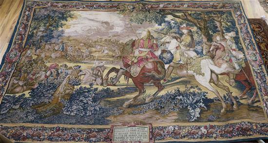 A tapestry wall hanging, battle scene 5ft 9in. x 8ft 5in.